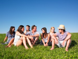 Group sitting in meadow